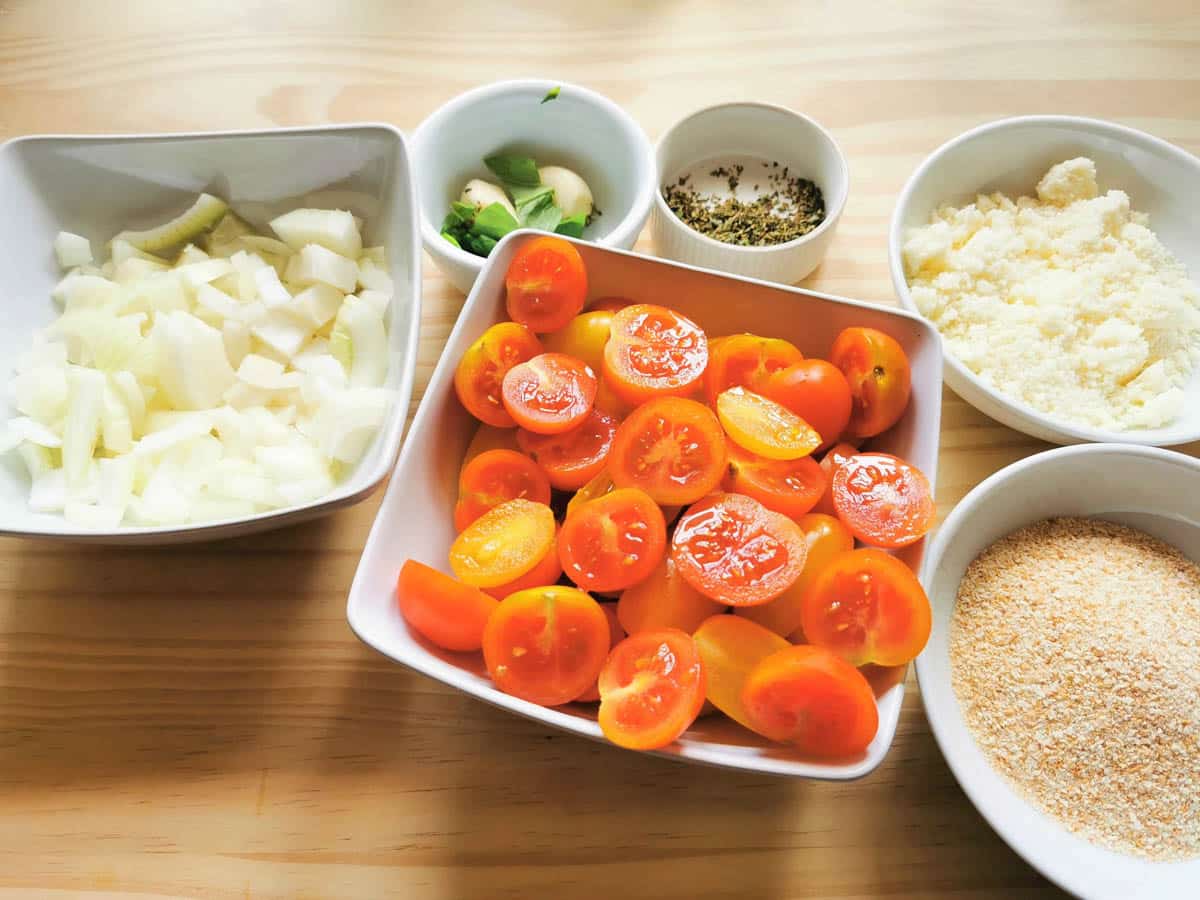 Ingredients for the roasted tomato pasta prepped and portioned in dishes.