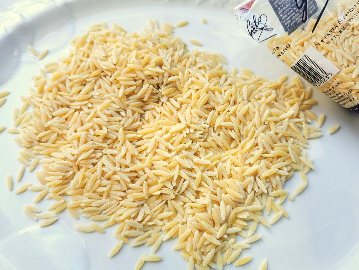 Orzo/risoni pasta on white plate.