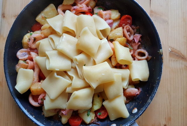 paccheri with calamari and potato in frying pan