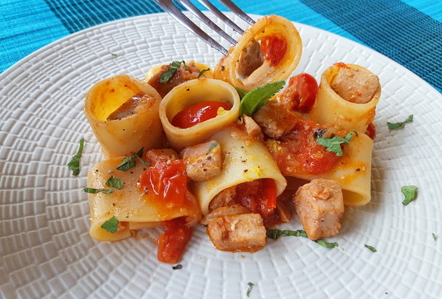 mezzi paccheri with fresh tuna ragu on white plate