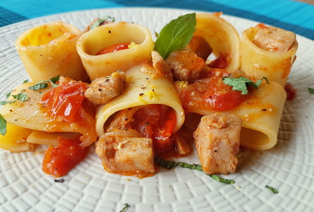 paccheri pasta with fresh tuna ragu on white plate