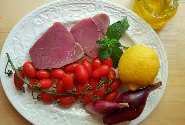 ingredients for fresh tuna ragu on white plate