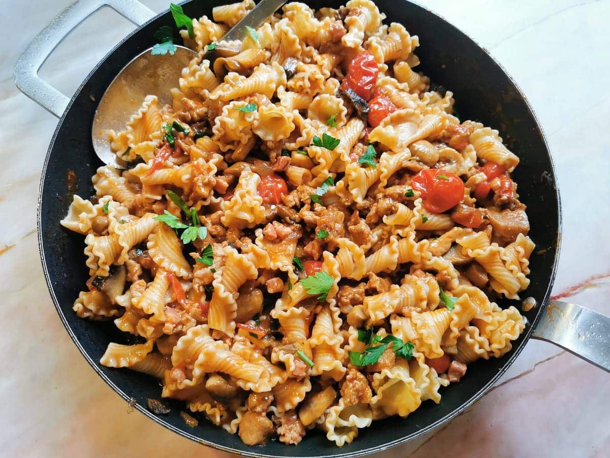 Ready campanelle pasta alla boscaiola in skillet.