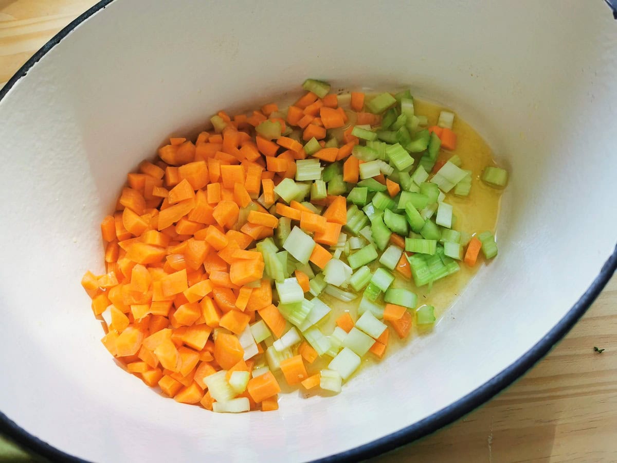 Chopped carrots and celery in Dutch oven.