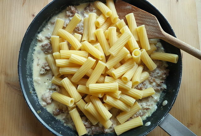 Italian maccheroni and sausage and cream pasta sauce alla norcina in frying pan