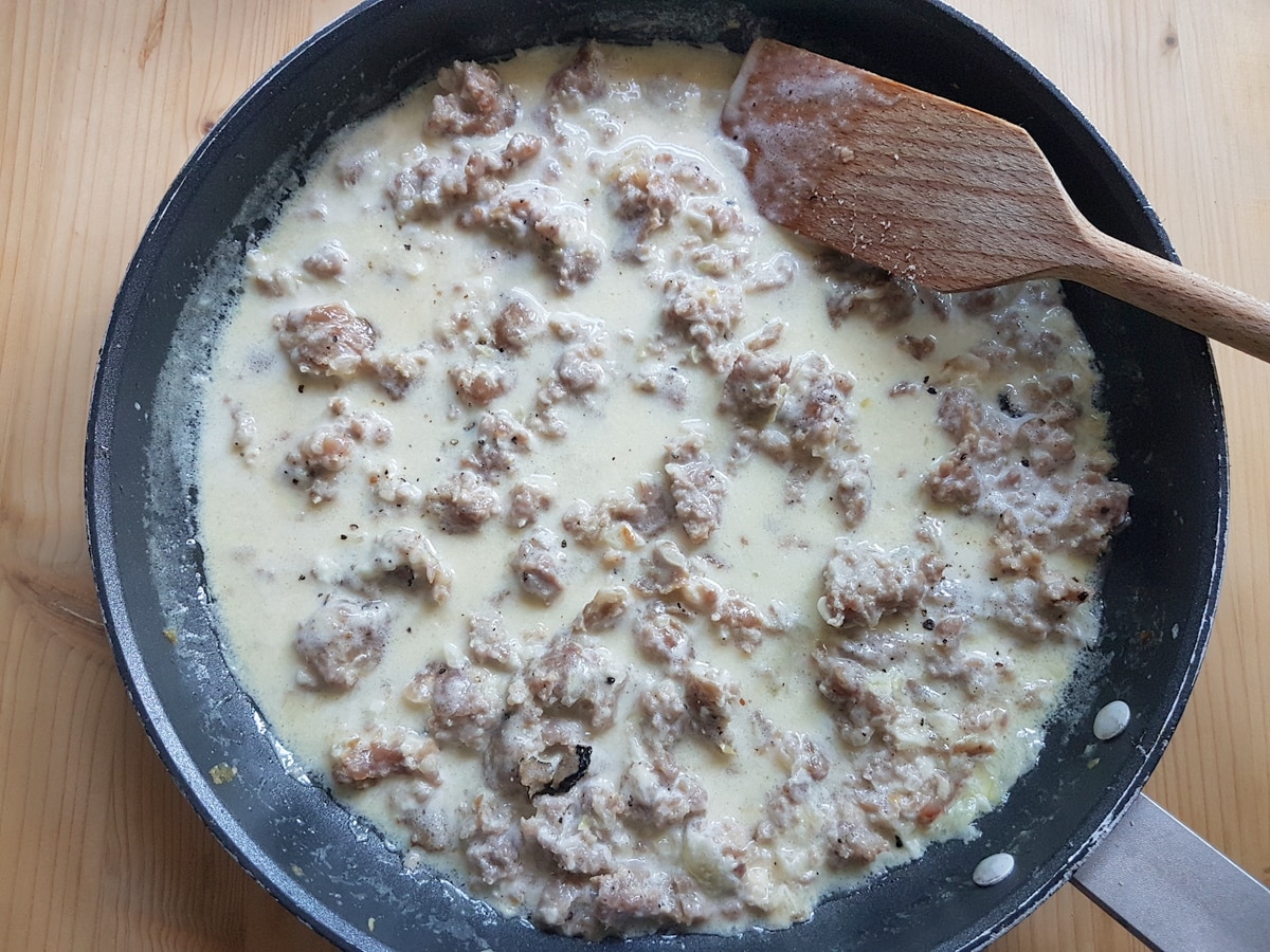 Fresh cream, truffle and pecorino added to the sausage and onions in the pan.