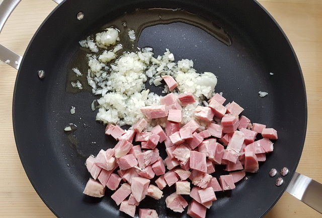 chopped ham and chopped onion in frying pan