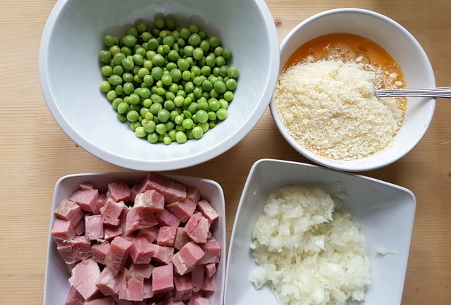 chopped ham, shelled peas, chopped onion and beaten eggs in separate white bowls