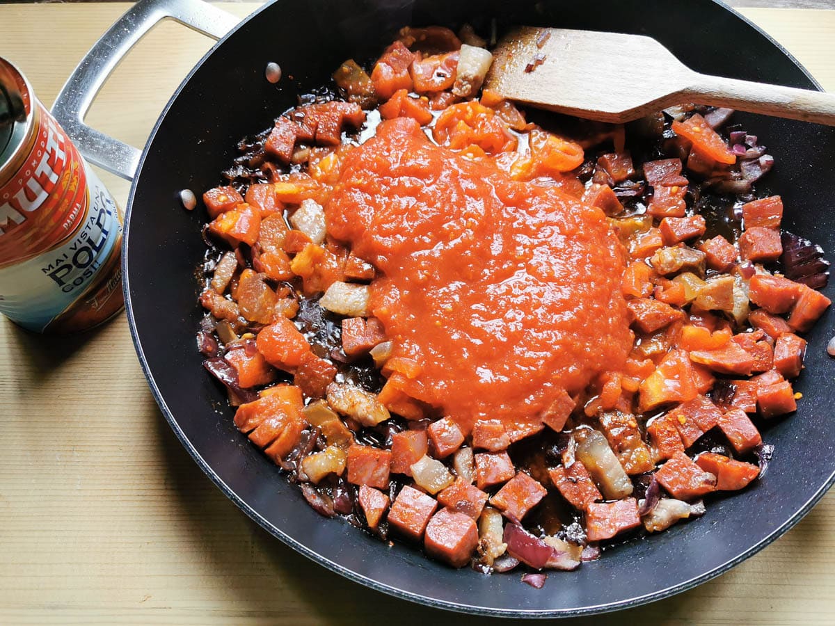 Tomato passata added to the pan.