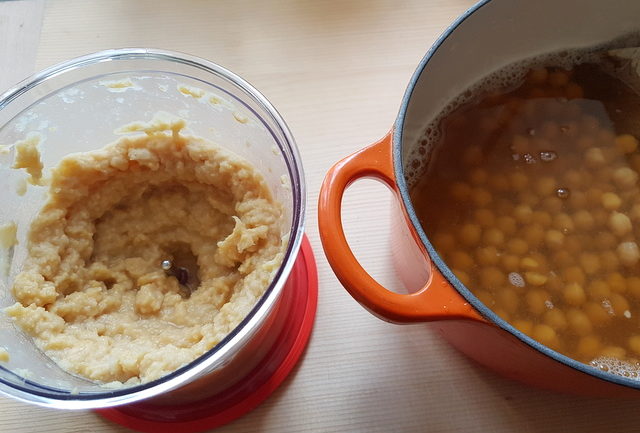 pureed chickpeas in blender and cooked chickpeas in pot