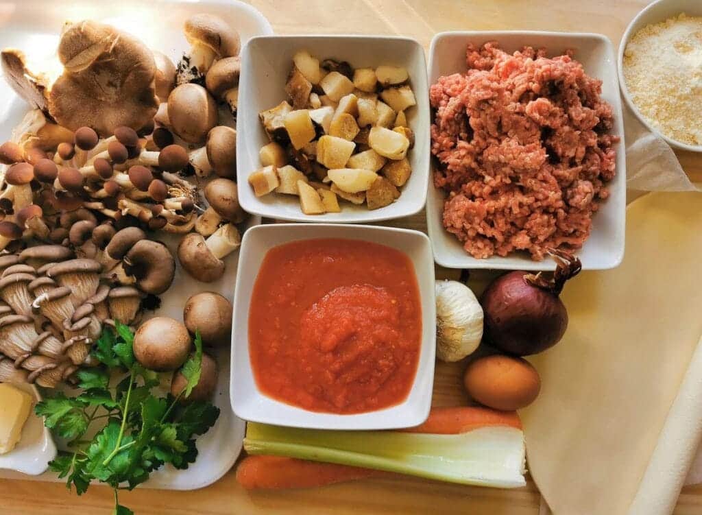 All the ingredients for pasta pie with pastry on wooden board