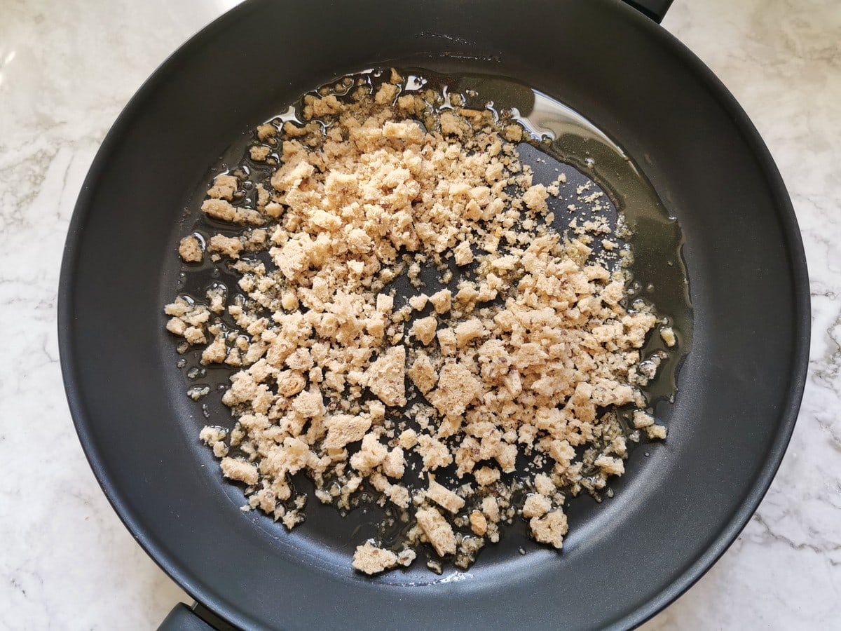 Fresh homemade breadcrumbs in skillet with olive oil.