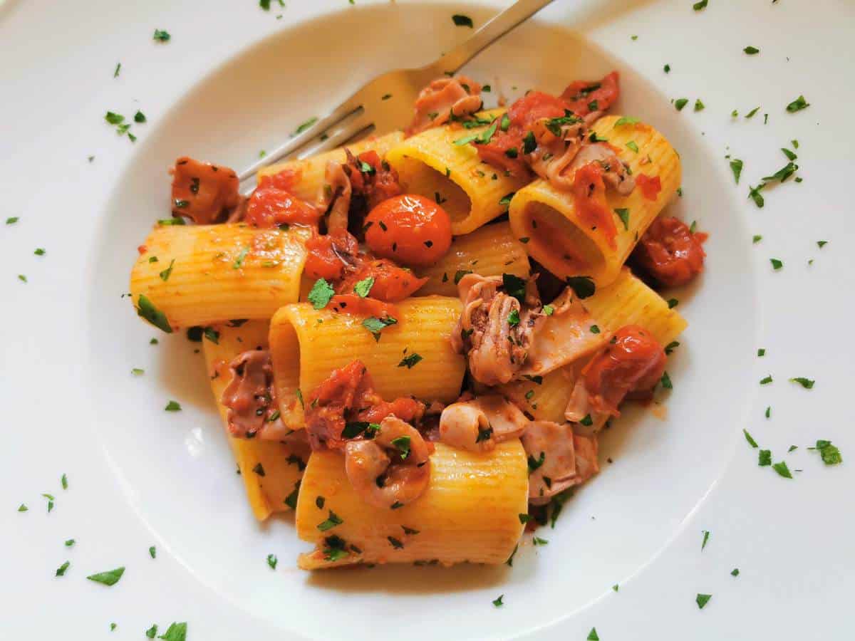 Pasta with calamari and tomatoes.