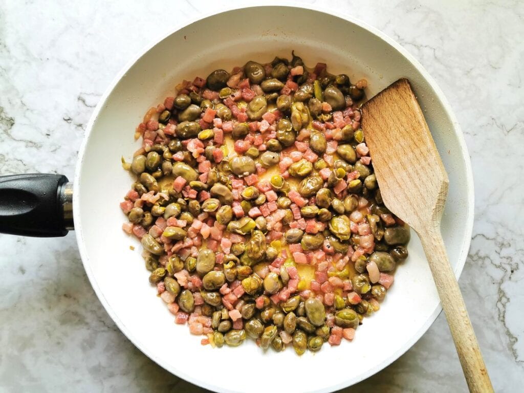 cooked fava beans and pancetta in pan