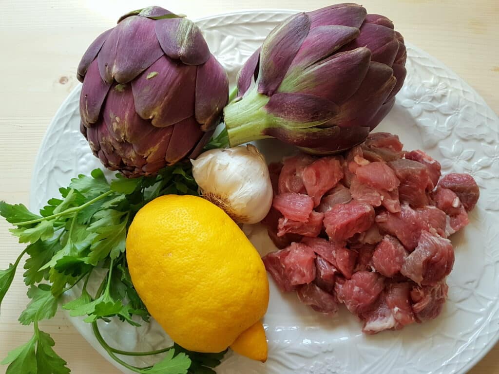 ingredients for pasta with lamb and artichokes on white plate