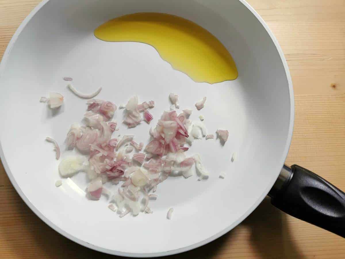 sliced shallots with olive oil in non stick pan