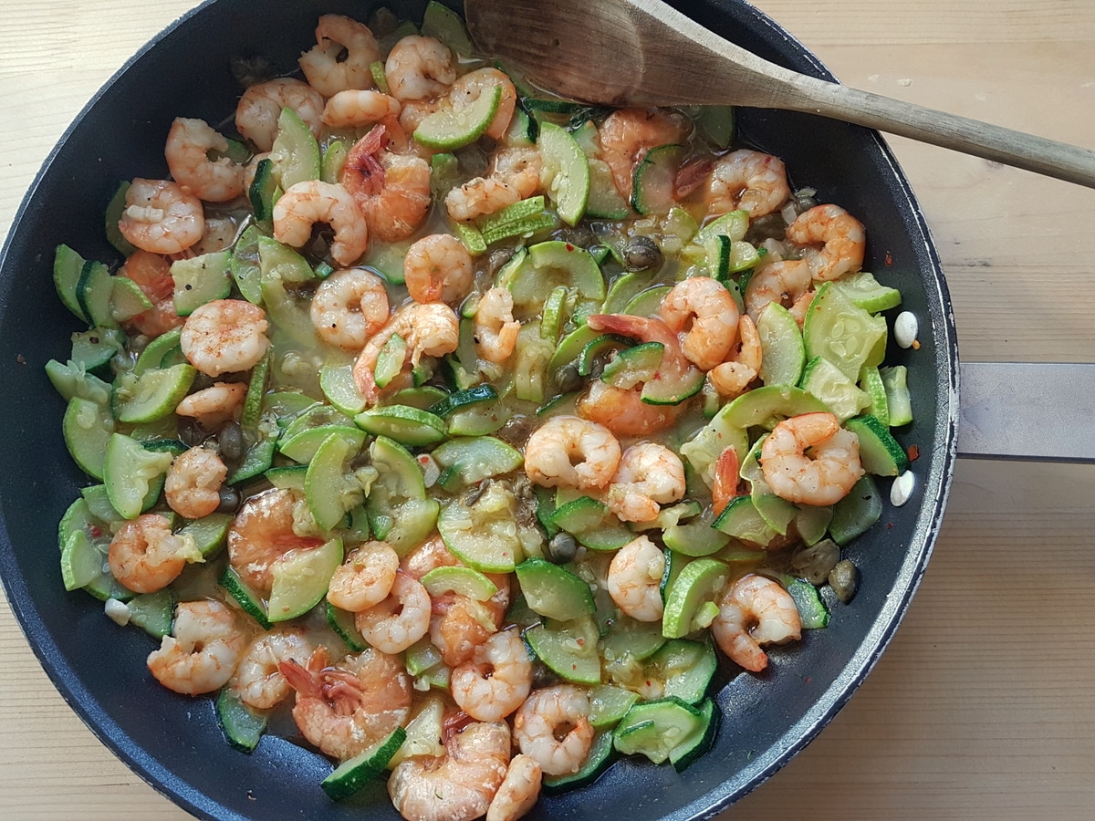 Zucchini and white wine added to the shrimp pan.