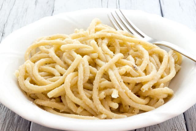 cooked Tuscan pici pasta in a white bowl