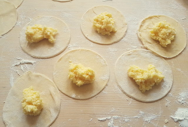 pasta dough discs with baked ravioli filling in centre