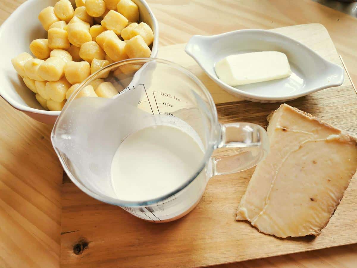 Ingredients for this gnocchi recipe on wood board.