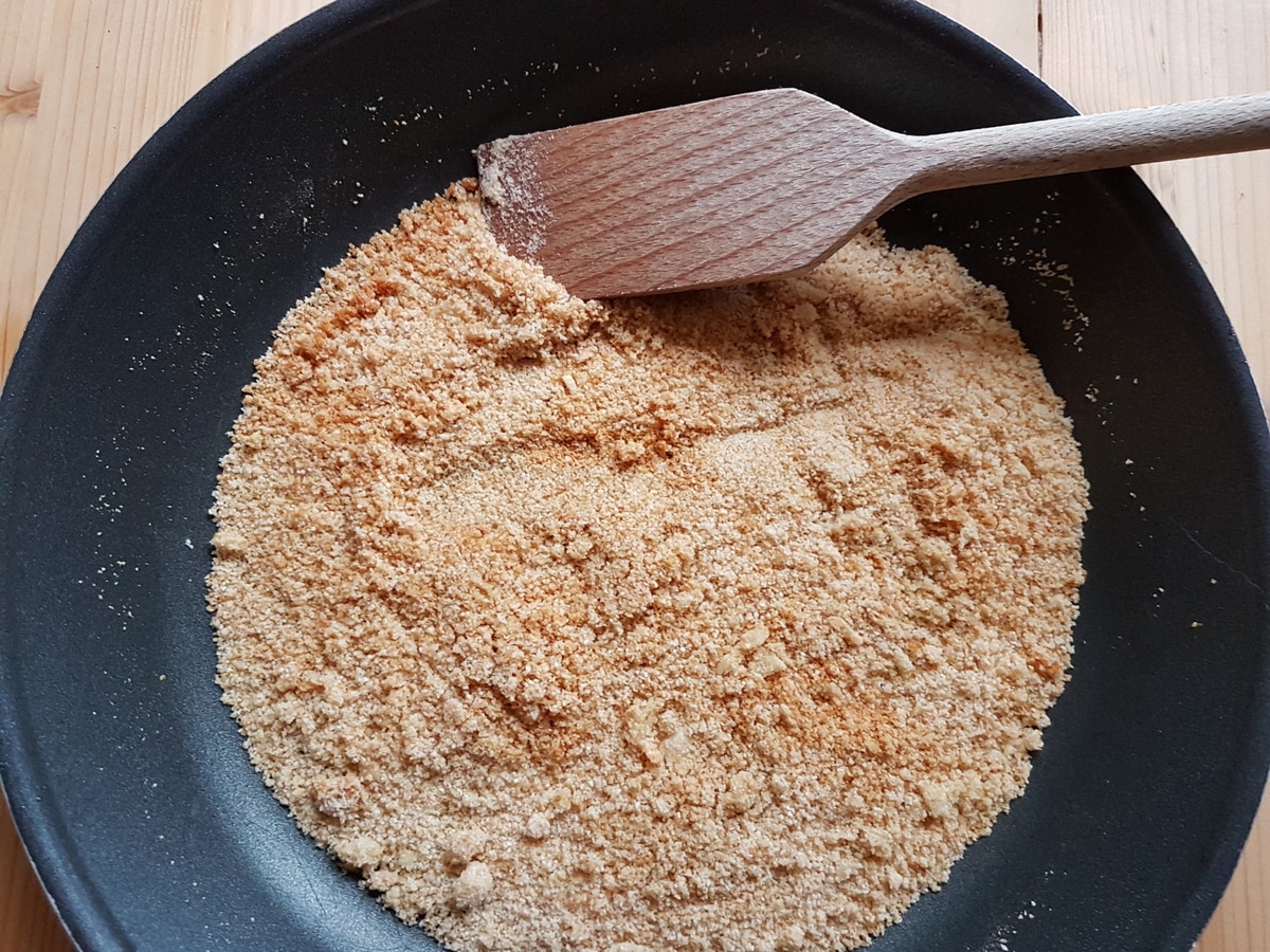 Breadcrumbs toasting in a pan.