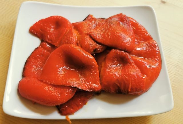 peeled roasted red peppers on white plate