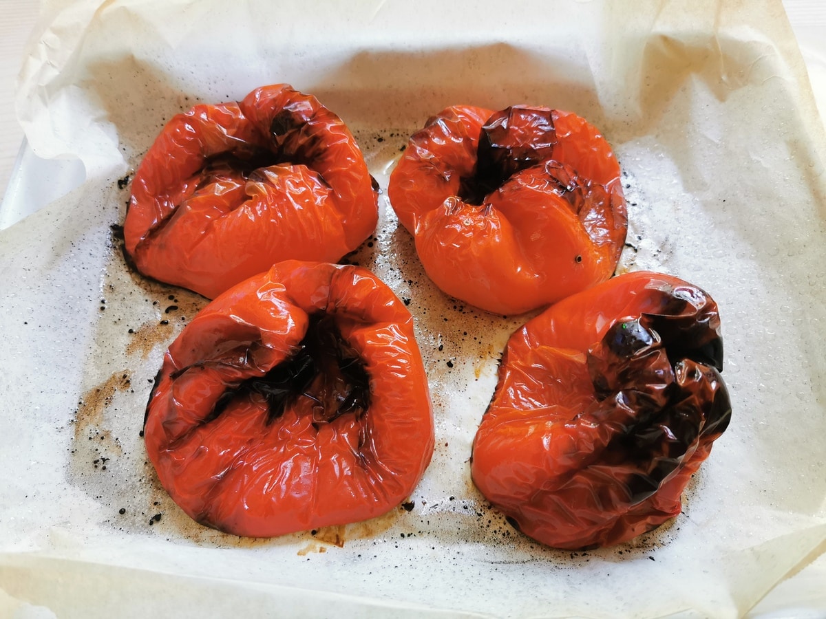 Roasted bell peppers on a baking tray.