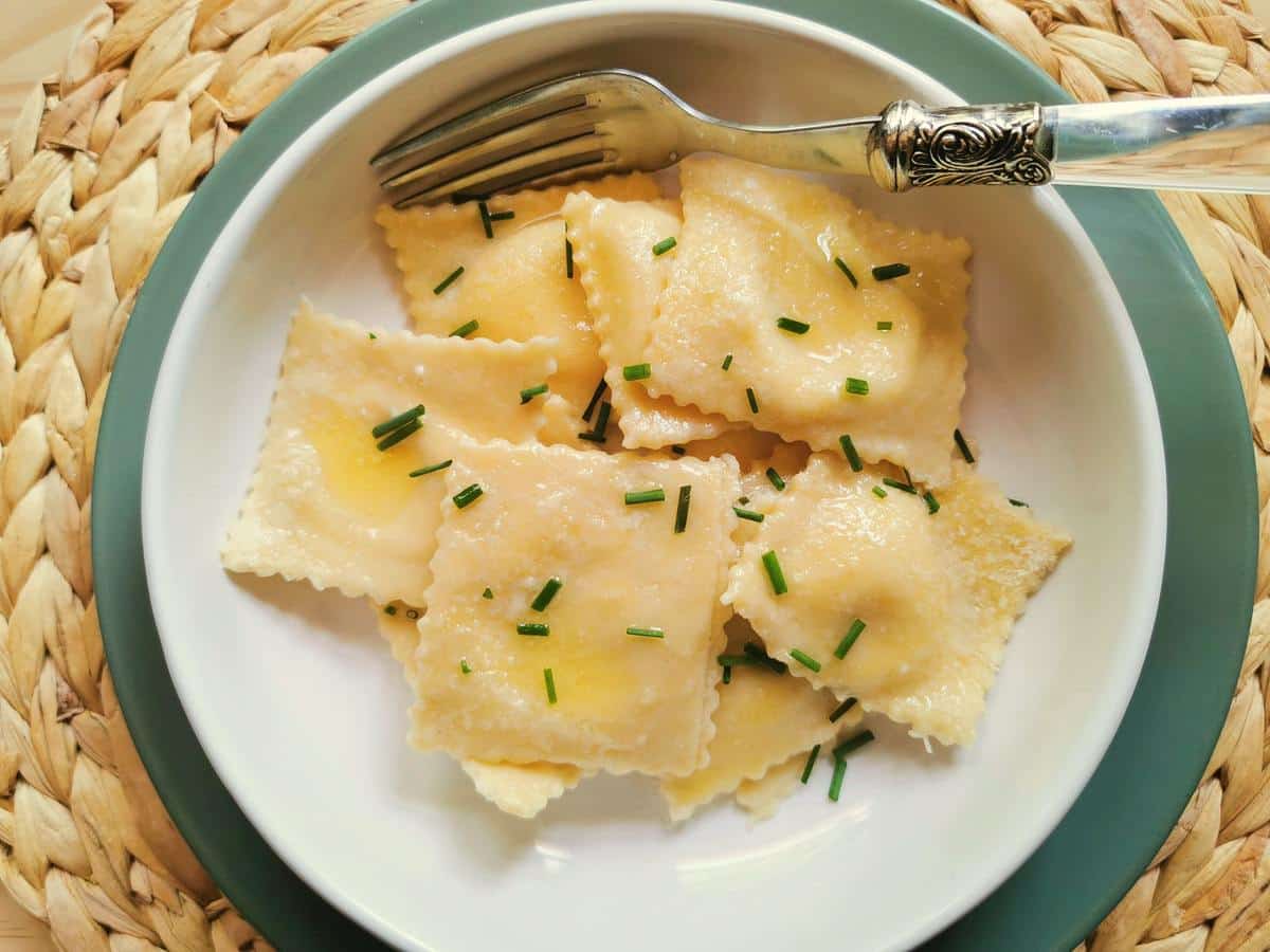 Robiola cheese ravioli in white bowl.