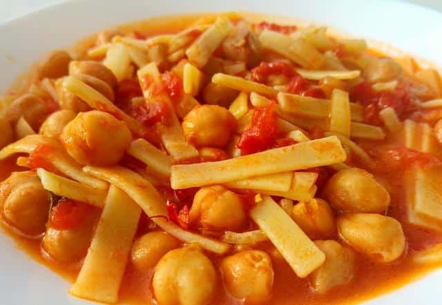 sagne pasta with chickpeas and tomatoes in white bowl