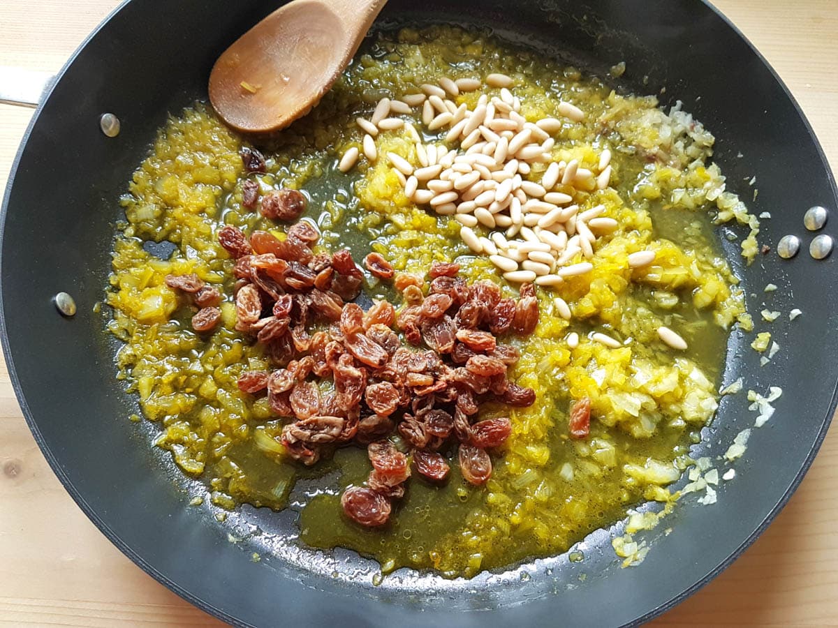 Adding raisins, pine nuts, saffron and chopped fennel to the softened onions