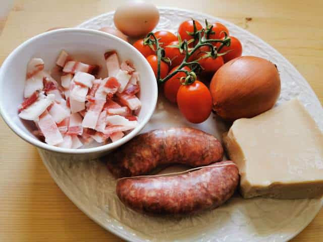 ingredients for rigatoni alla zozzona on white plate