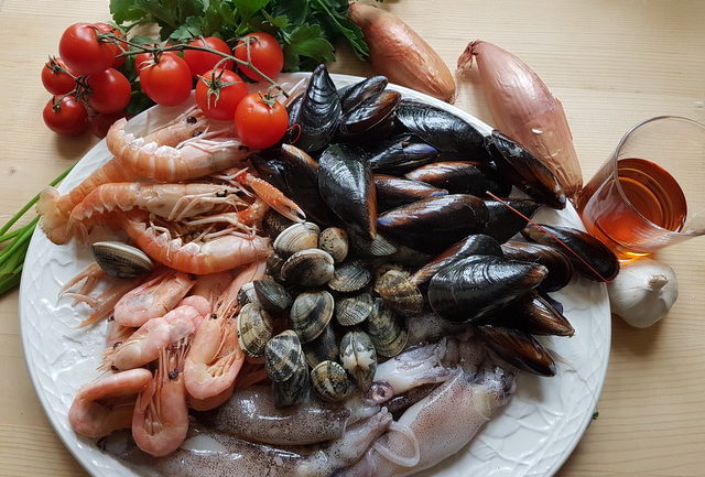 ingredients for seafood sauce on white plate