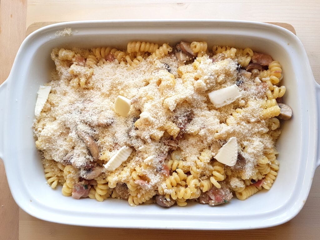 short fusilli bucati with gorgonzola, pancetta and mushrooms ready to go on the oven