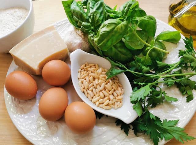 ingredients for silk handkerchief pasta with pesto on white plate