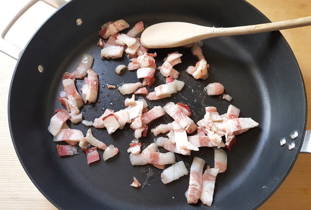 uncooked guanciale (pork cheek) in frying pan