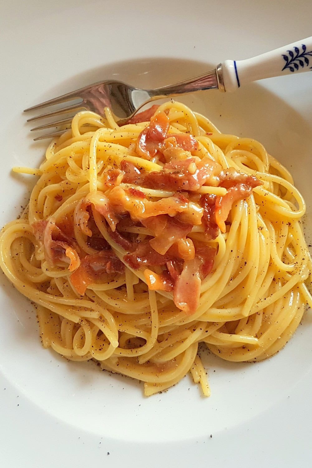 Authentic spaghetti alla carbonara in white bowl.