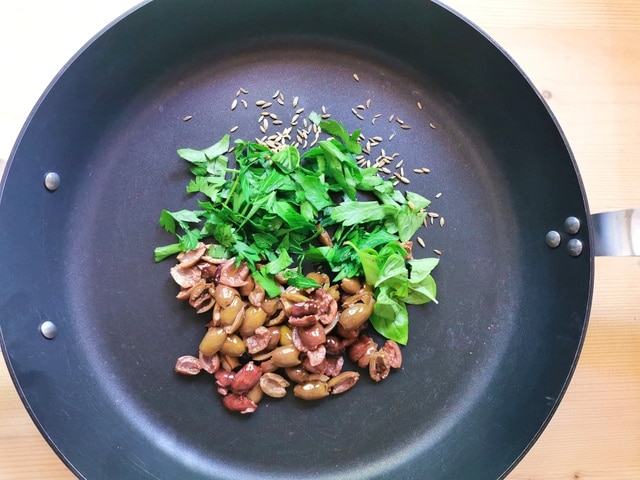 chopped olives and parsley in skillet with fennel seeds.