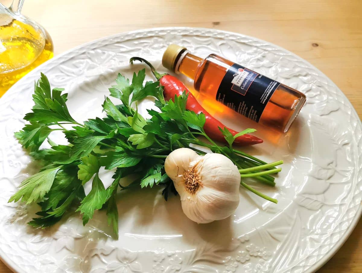 ingredients for spaghetti alla colatura on white plate