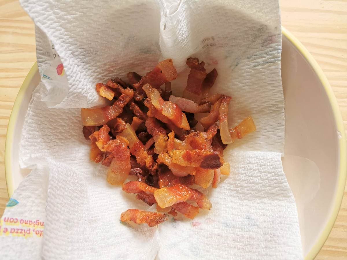 Crispy guanciale in a dish on a paper towel.