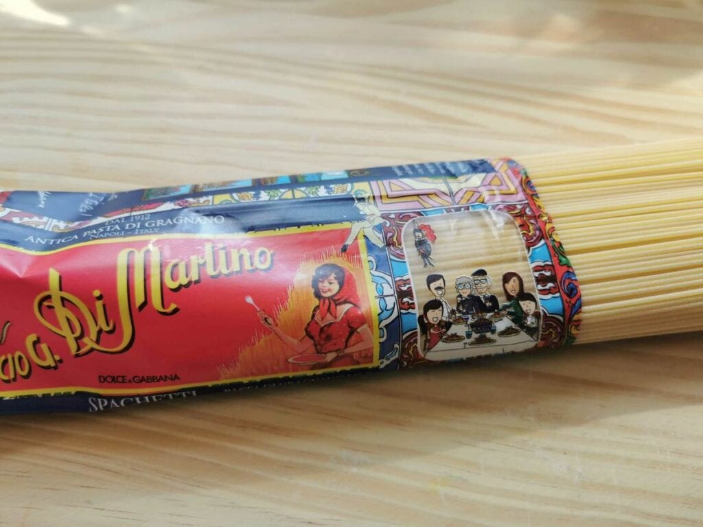 Packet of spaghetti Di Martino on wood worktop.