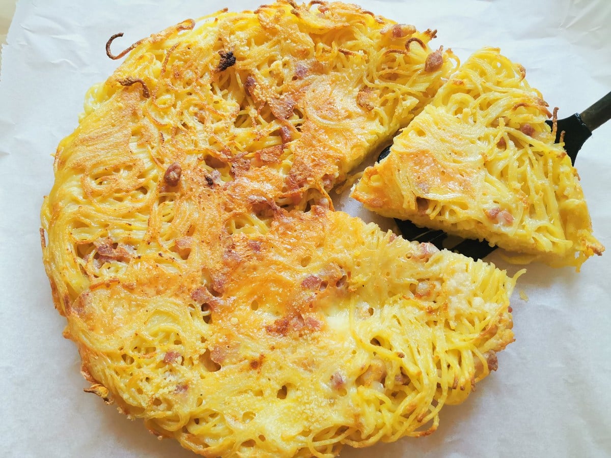 Leftover spaghetti frittata on sheet of baking paper.