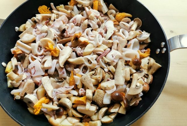 mushrooms, calamari and garlic cooking in skillet