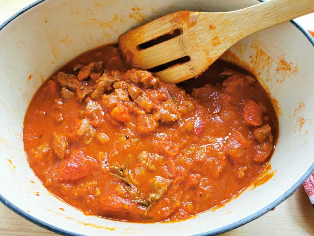 ready lamb ragu in Dutch oven