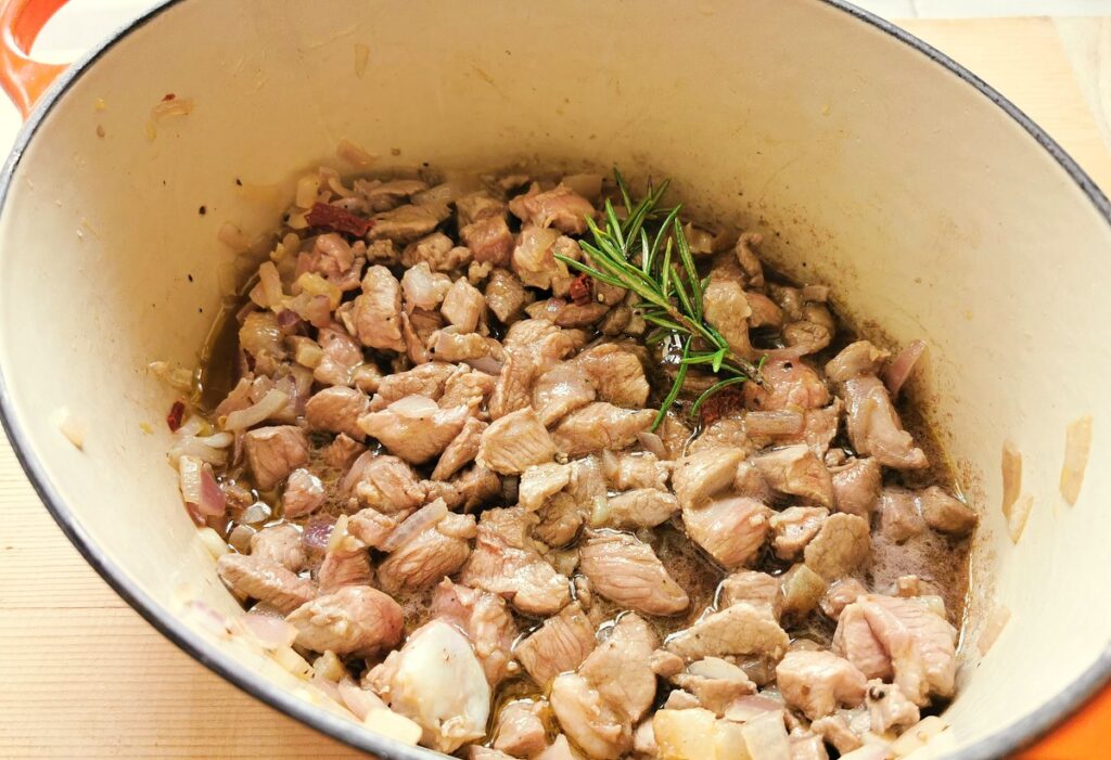 Browned lamb in the pot with wine