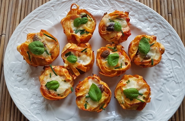 tagliatelle pasta muffin nests on a white oval dish