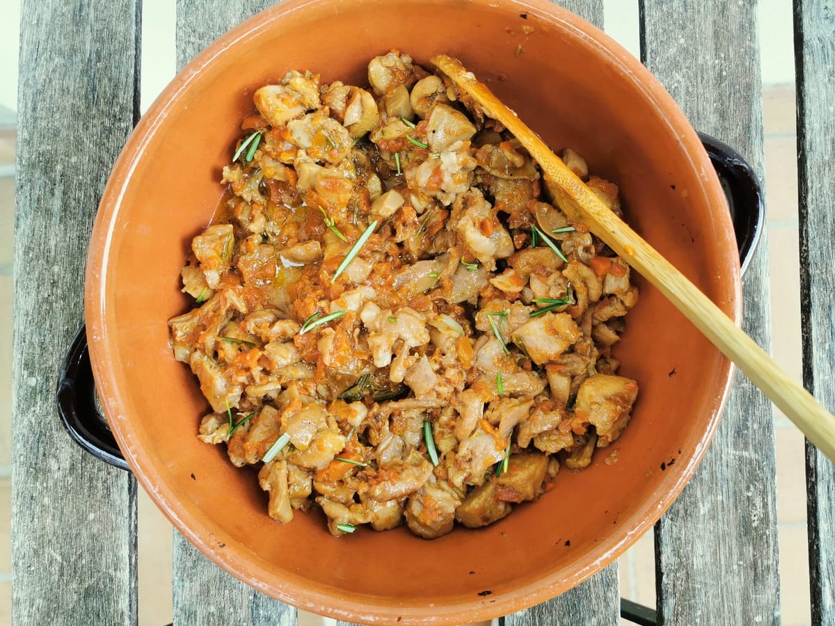 Rabbit ragu in terracotta dish.