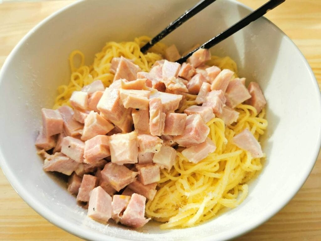 ham and cream sauce added to cooked pasta