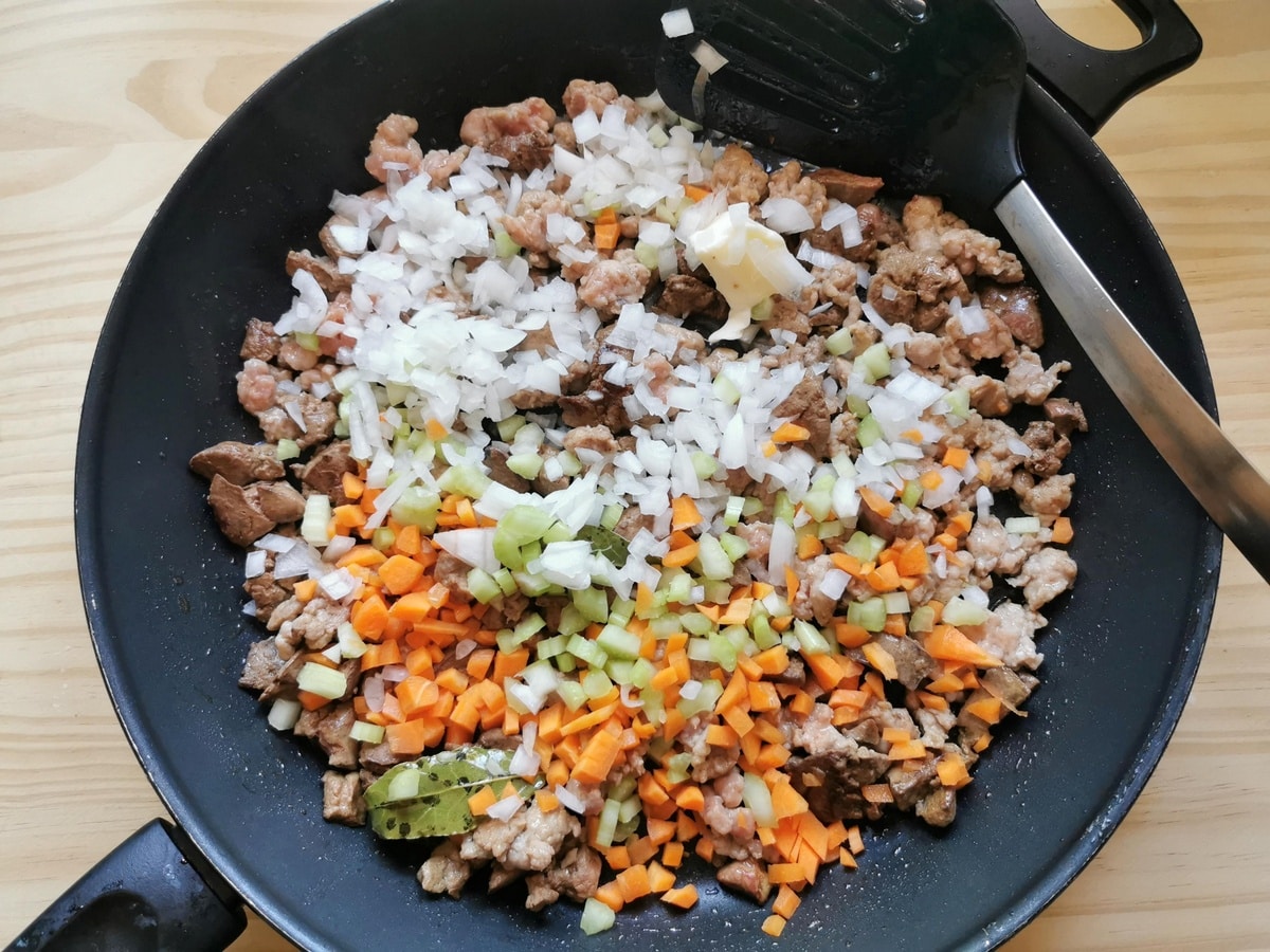 Chopped onion, carrot and celery added to the pan