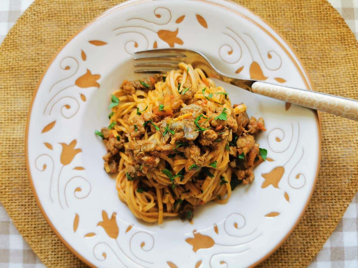 Tagliolini pasta alla Langarola in a bowl and garnished with fresh parsley.