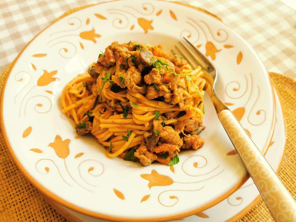 A portion of tagliolini alla langarola in a bowl with a fork.